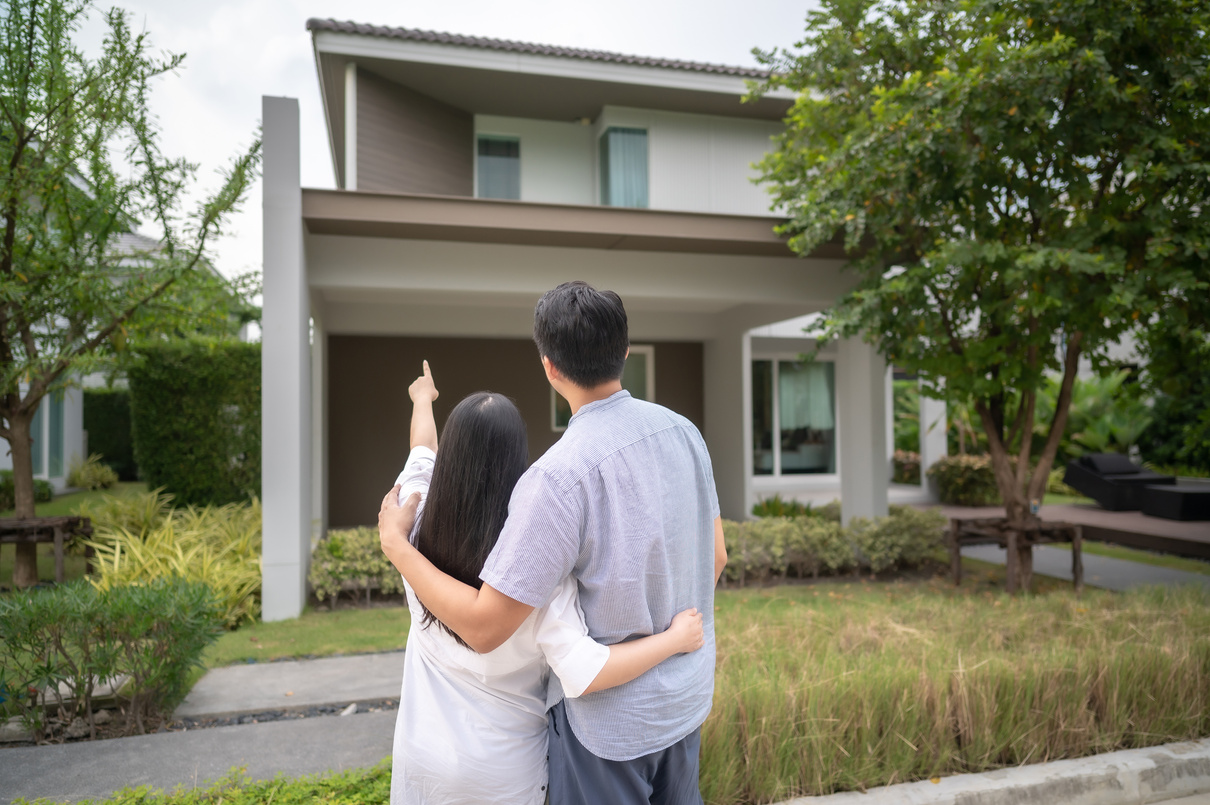 Asian Couple in Front of Thier New House